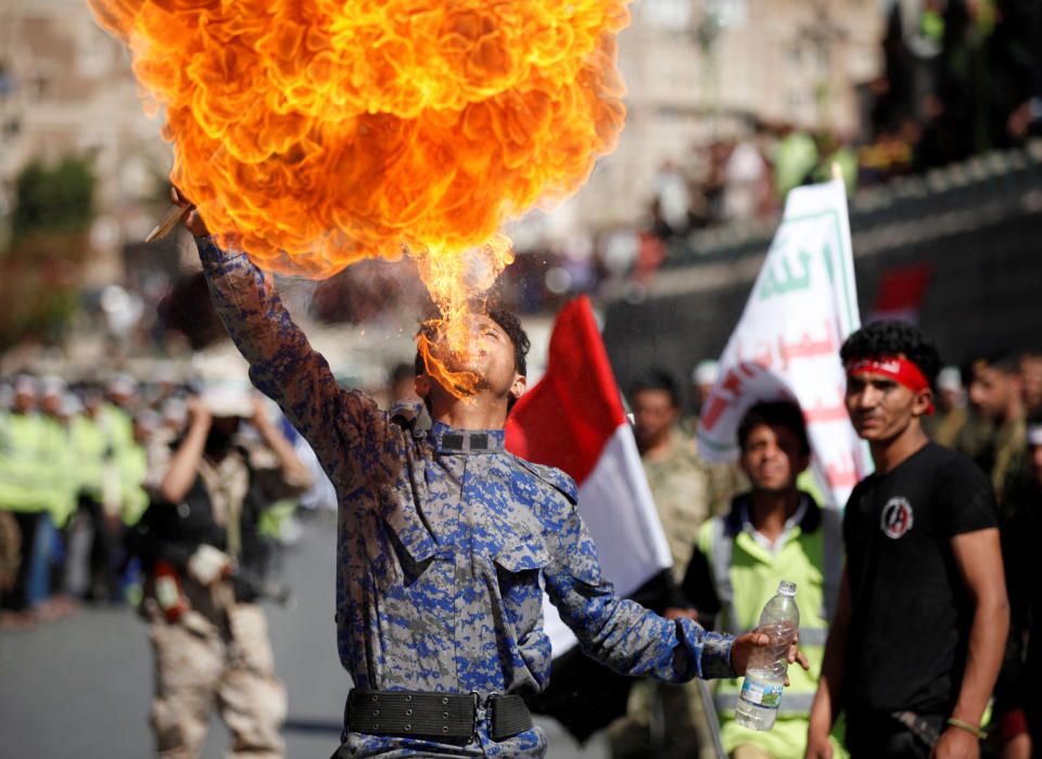 Un militante Houthi escupe fuego en un festival previo al enfrentamiento con las fuerzas gubernamentales de Yemen.