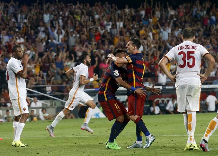 Barcelona's Lionel Messi and Neymar celebrate a goal against AS Roma during a friendly match at Camp Nou stadium in Barcelona