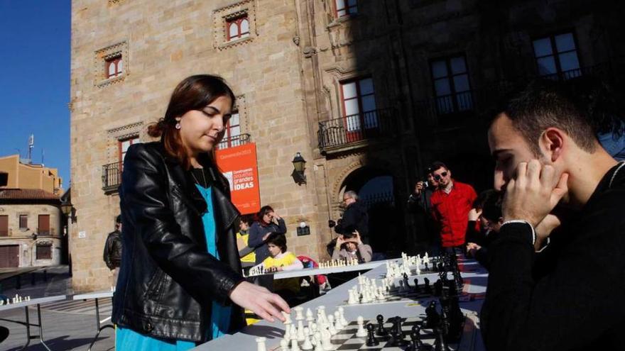 Ana Matnadze, ayer, en la plaza del Marqués, moviendo una pieza durante la partida simultánea de ajedrez.