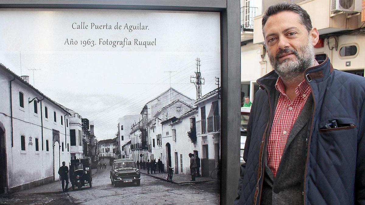 Manuel Carmona, junto a una foto de la Puerta de Aguilar, en una estampa icónica.