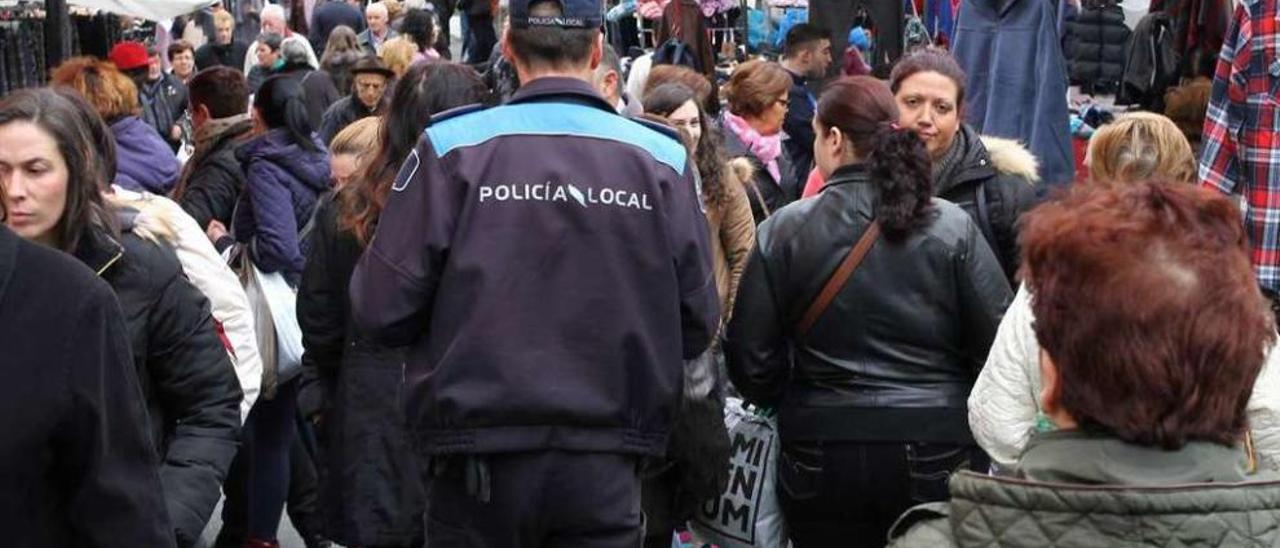 Un guardia municipal controla los puestos de la feria de Lalín. // Bernabé/Gutier