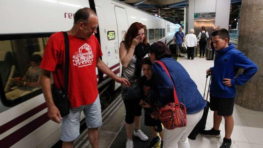 Miguel Salvadó y su cuñada, Isabel Corral, reciben a María Teresa Salvadó (segunda por la izquierda) y a sus hijos, tras apearse del tren procedente de Barcelona, anoche, en la estación de ferrocarril de Oviedo.