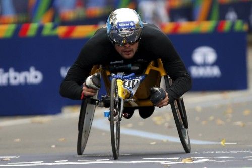Marcel Hug of Switzerland crosses the finish line to place third in the men's wheelchair division of the 2015 New York City Marathon in New York's Central Park