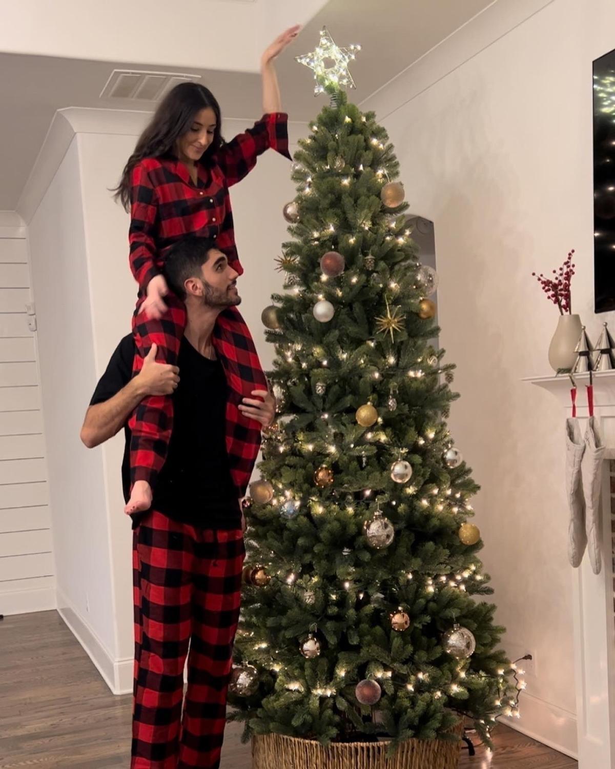 Santi Aldama coloca junto a su novia, Pilar Barquin, la estrella navideña en el árbol