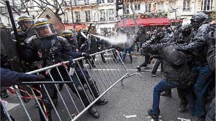 Agents antiavalots utilitzen gasos lacrimògens contra els manifestants a la plaça de la República de París.