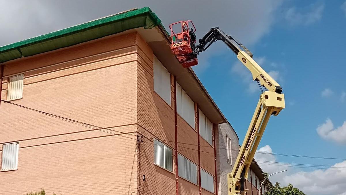 Coolocación de una malla protectora para evitar la caída de cascotes en el CEIP Cervantes de La Pobla.