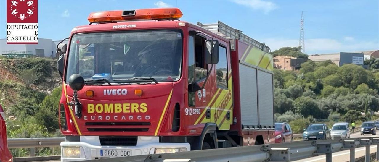 Los bomberos han acudido al rescate del motorista, que había caído dentro de una acequia de difícil acceso