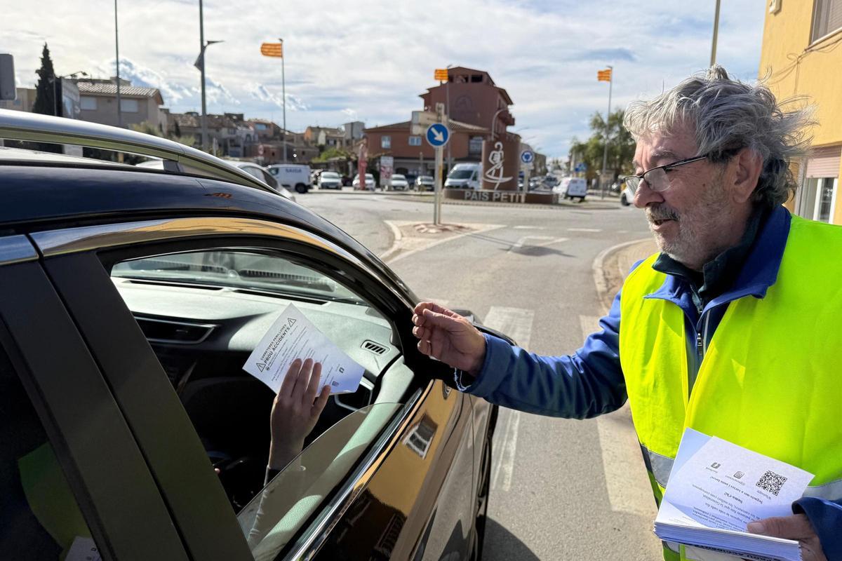 Un membre de la plataforma entrega una octaveta a un conductor