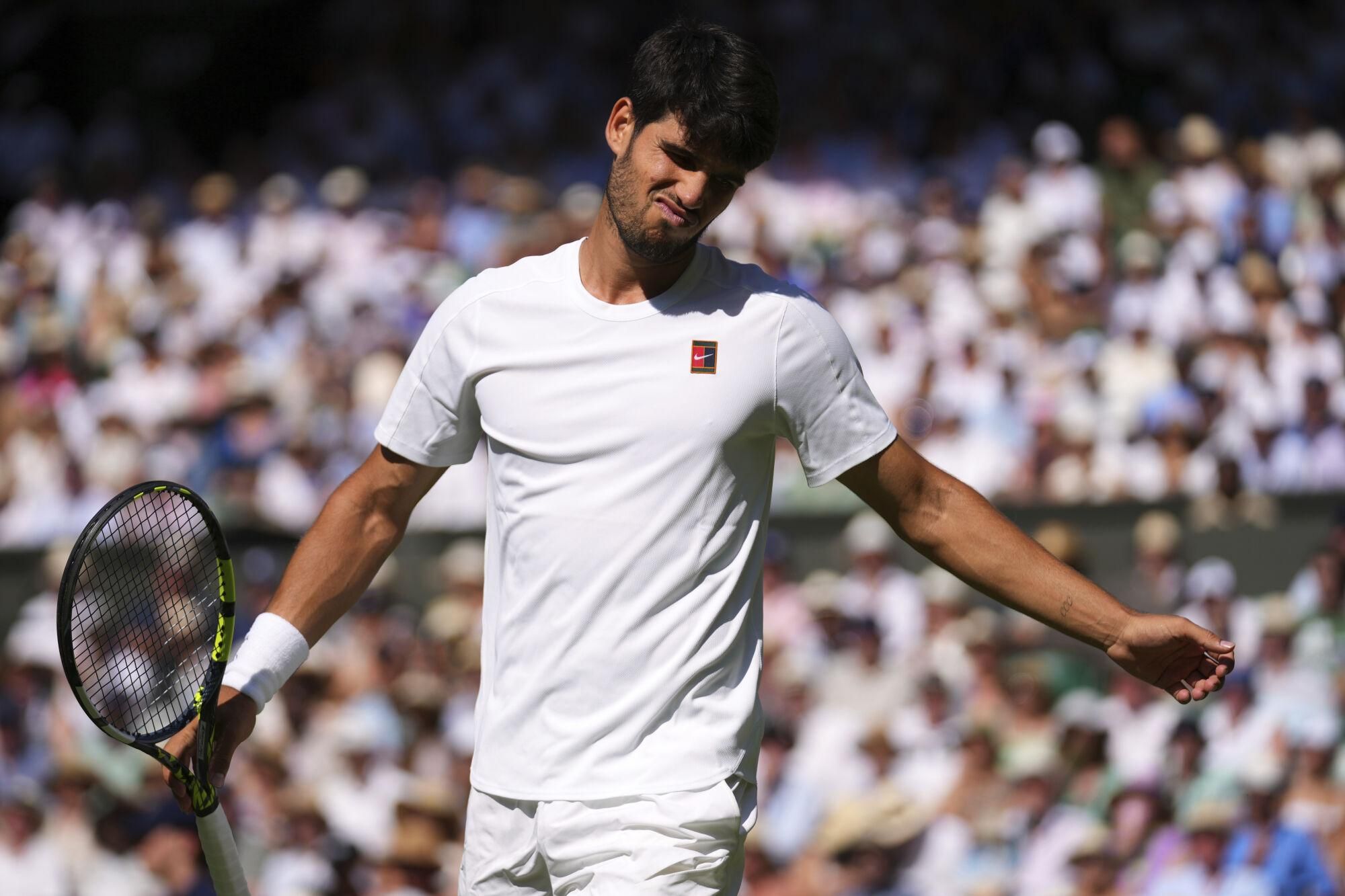 Carlos Alcaraz of Spain reacts during the men's semifinal singles match against Taylor Fritz of the U.S. at the Wimbledon Tennis Championships in London, Friday, July 11, 2025.(AP Photo/Joanna Chan)