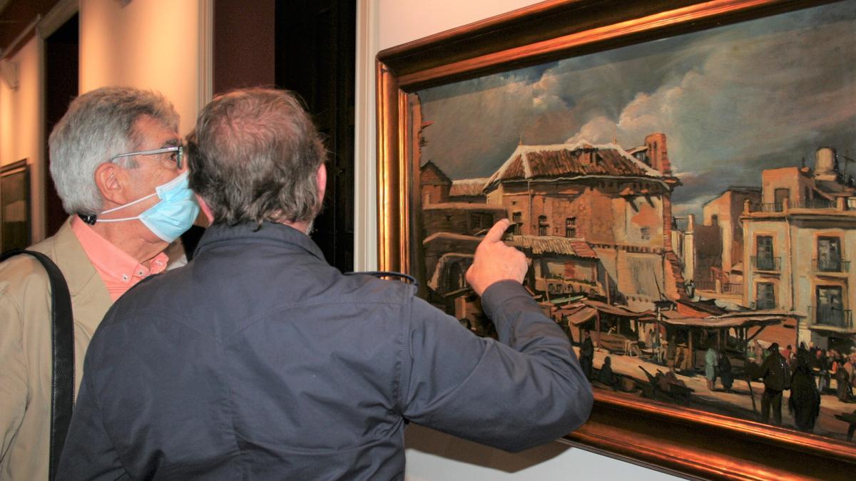 Dos visitantes contemplan una de las obras de Muñoz Barberán.