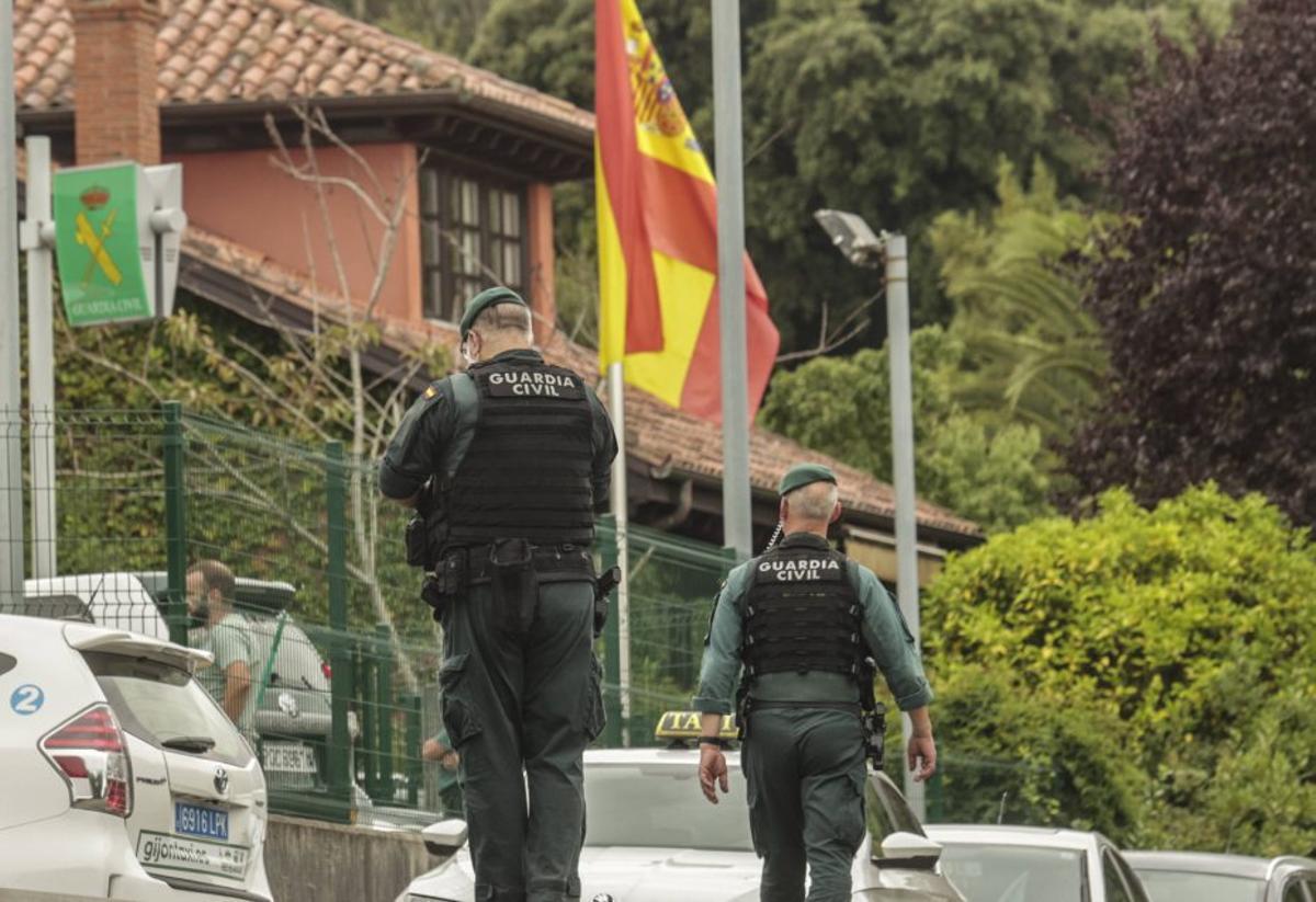 Una UVI Móvil y agentes de la Guardia Civil, ayer en el exterior del cuartel de Llanes tras el crimen y el tiroteo. | IRMA COLLÍN