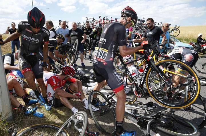 Riders and their bicycles fill the road after a fall during the third stage of the 102nd Tour de France cycling race from Anvers to Huy