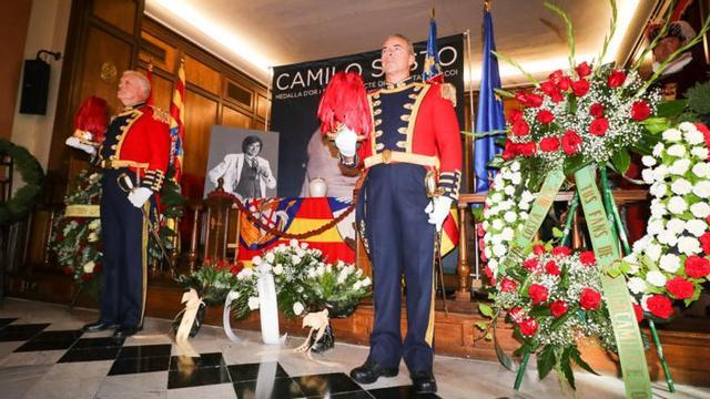 La urna con las cenizas custodiada por policías locales con el traje de gala.