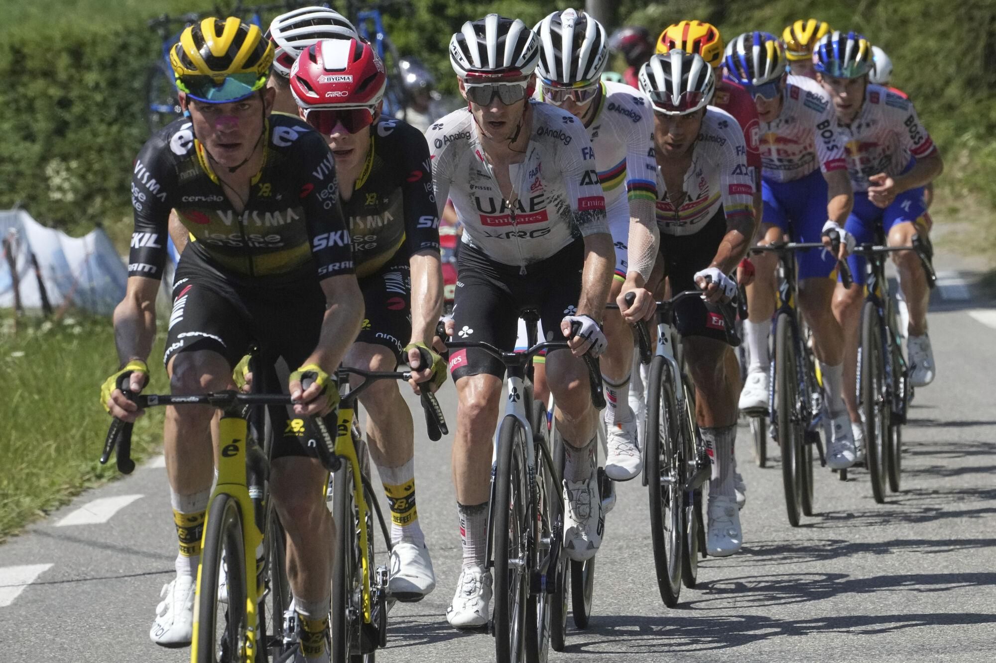 Sepp Kuss of the U.S. sets the pace for team leader Denmark's Jonas Vingegaard, followed by Britain's Adam Yates and his team leader Slovenia's Tadej Pogacar during the twelfth stage of the Tour de France cycling race over 180.6 kilometers (112.2 miles) with start in Auch and finish in Hautacam, France, Thursday, July 17, 2025. (AP Photo/Thibault Camus)
