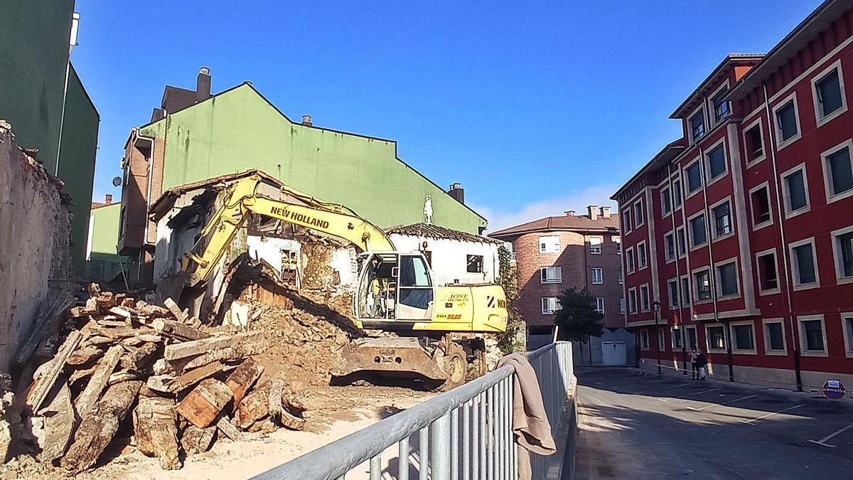 Tareas de demolición, ayer, de un inmueble de la calle San Antonio de Arriondas. | Eva San Román