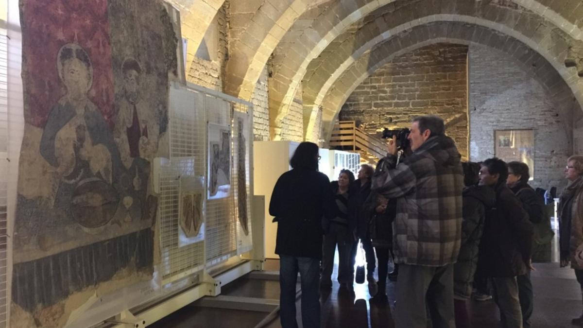 Los visitantes frente a las cuatro pinturas que se pueden ver, detrás se aprecian los peines con el resto de murales.
