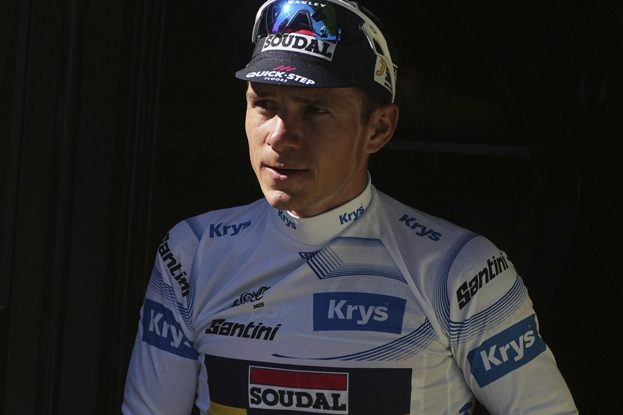 Belgium's Remco Evenepoel wearing the best young rider's white jersey arrives on the podium after the sixth stage of the Tour de France cycling race over 201.5 kilometers (125.2 miles) with start in Bayeux and finish in Vire Normandy, France, Thursday, July 10, 2025. (AP Photo/Thibault Camus)
