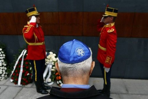Member of Romania's Jewish community lays a wreath during ceremonies at Holocaust memorial in Bucharest