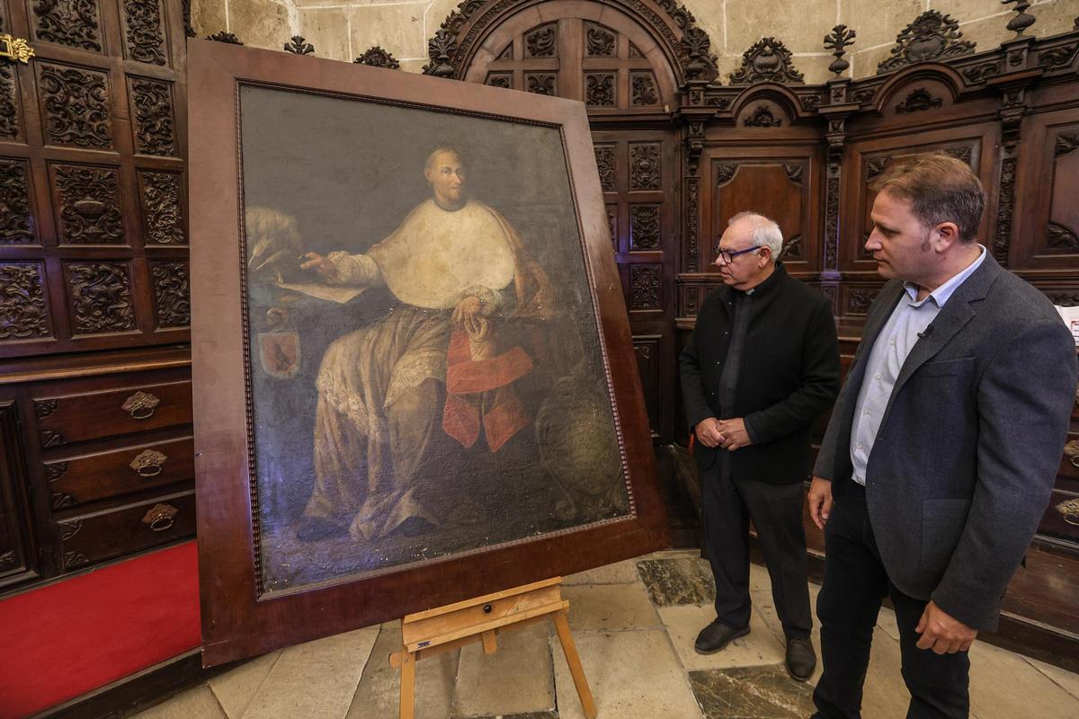 El deán de la Catedral de Orihuela, José Antonio Gea, y el conservador del Museo de Arte Sacro, Mariano Cecilia, observan el retrato de Juan Viudes.