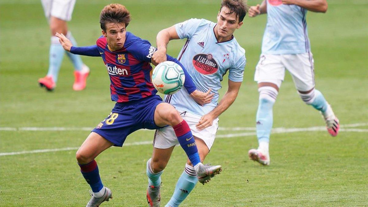 Denis Suárez disputa un balón con Riqui Puig