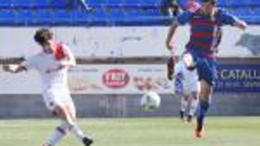 Manel prova un xut davant l&#039;oposició d&#039;un jugador del Mallorca B durant el partit de diumenge.
