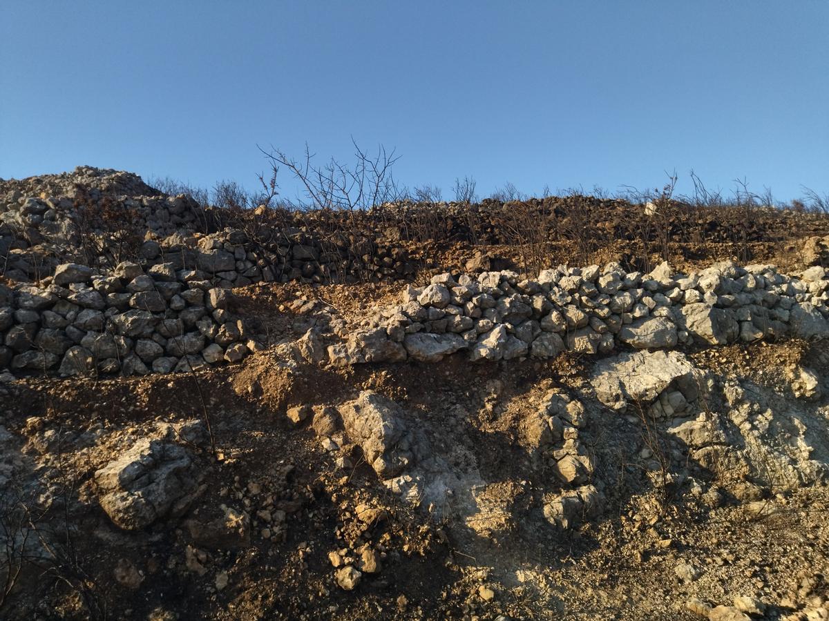 Muros de "pedra seca" deteriorados y que ahora son esenciales para frenar la erosión
