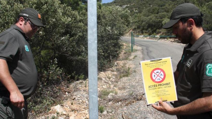 Agents rurals amb un cartell on s&#039;anuncia que es prohibeix l&#039;accés a un massís | ACN