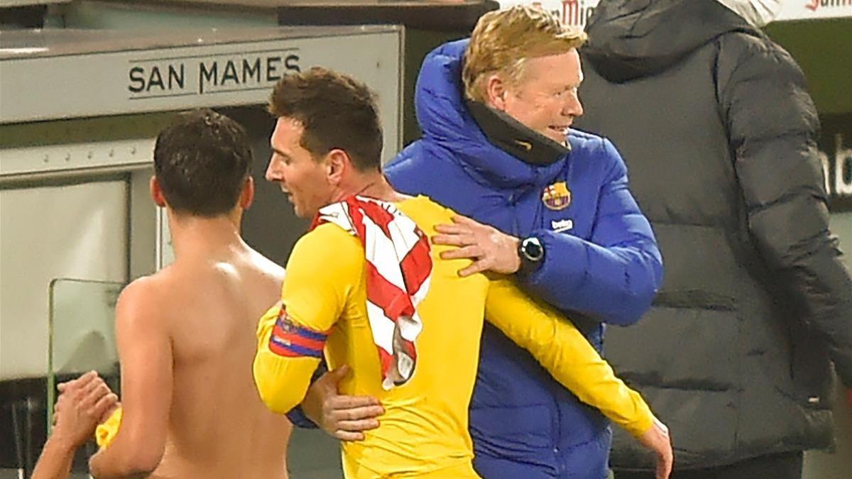 Barcelona s Dutch coach Ronald Koeman (back) hugs Barcelona s Argentinian forward Lionel Messi at the end of the Spanish League football match between Atheltic Bilbao and Barcelona at the San Mames Stadium in Bilbao on January 6  2021  (Photo by ANDER GILLENEA   AFP)