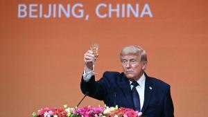 TOPSHOT - US President Donald Trump makes a toast as he attends a state banquet with Chinas President Xi Jinping at the Great Hall of the People in Beijing on May 14, 2026. (Photo by Brendan SMIALOWSKI / AFP)