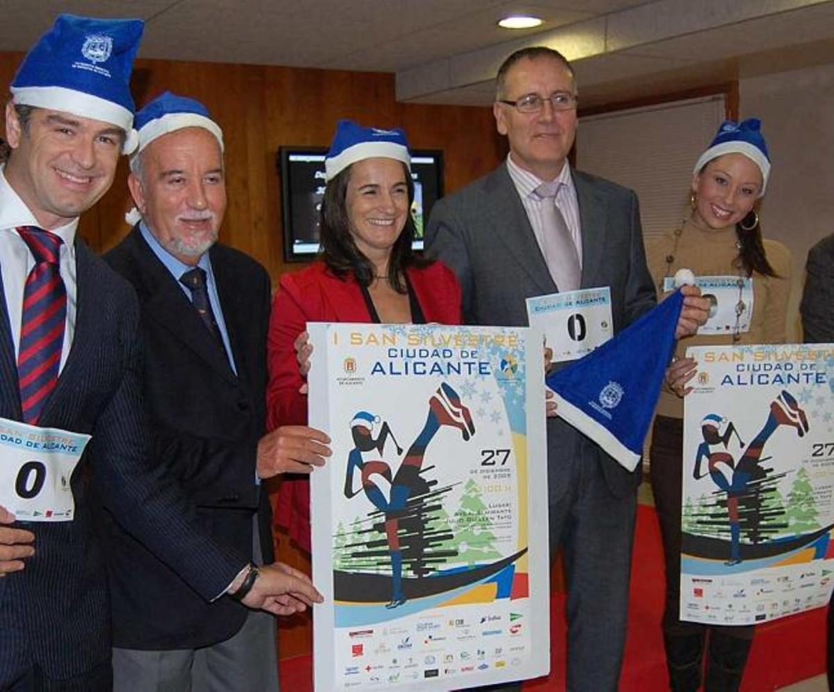Los ediles Miguel Valor e Isabel Fernández y los presentadores de la prueba, ayer, con los gorros que se regalarán