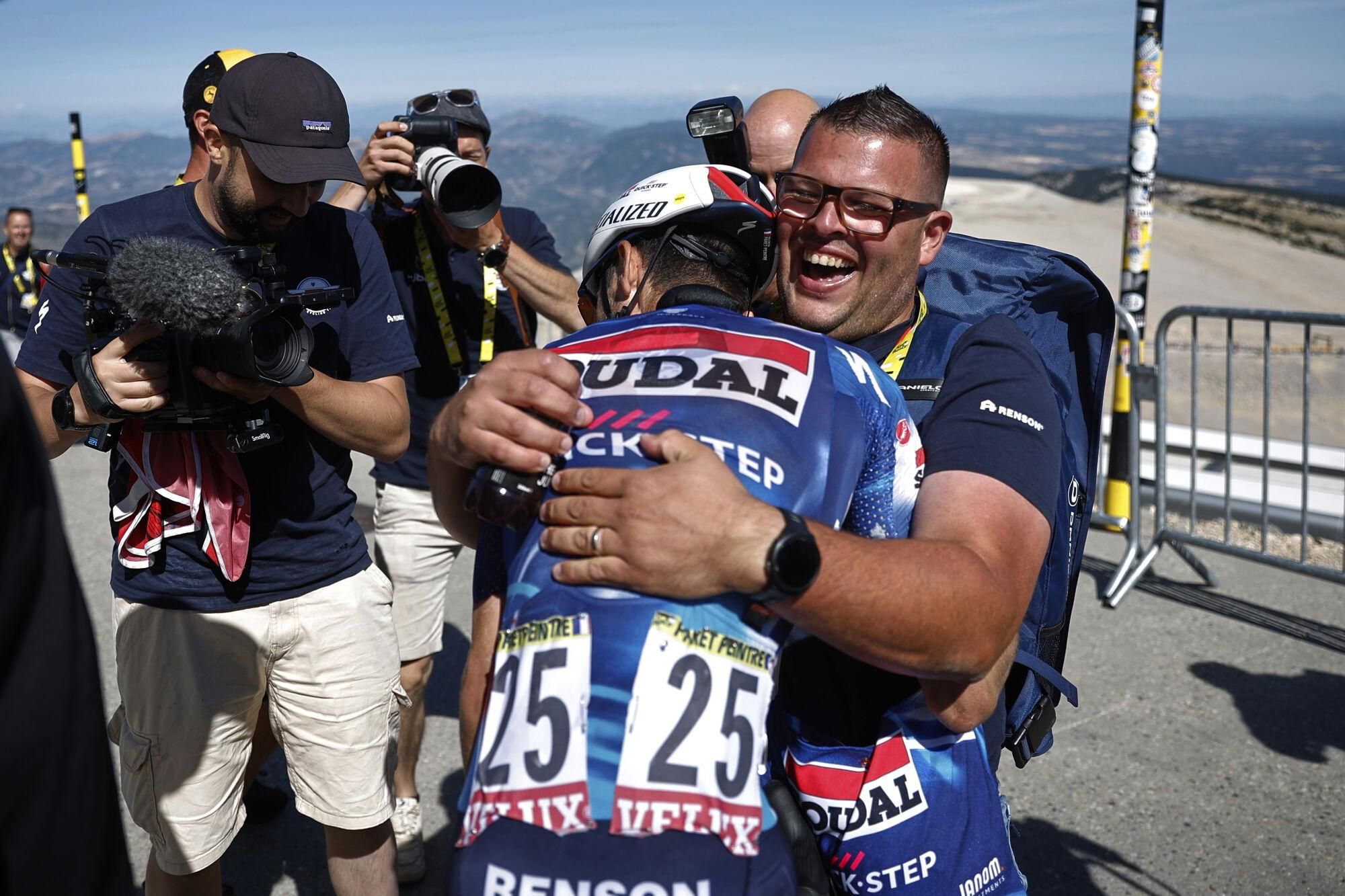 France's Valentin Paret Peintre is hugged after winning the sixteenth stage of the Tour de France cycling race over 171.5 kilometers (106.6 miles) with start in Montpellier and finish on the Mont Ventoux, France, Tuesday, July 22, 2025. (Martin Divisek/Pool Photo via AP). POOL PHOTO