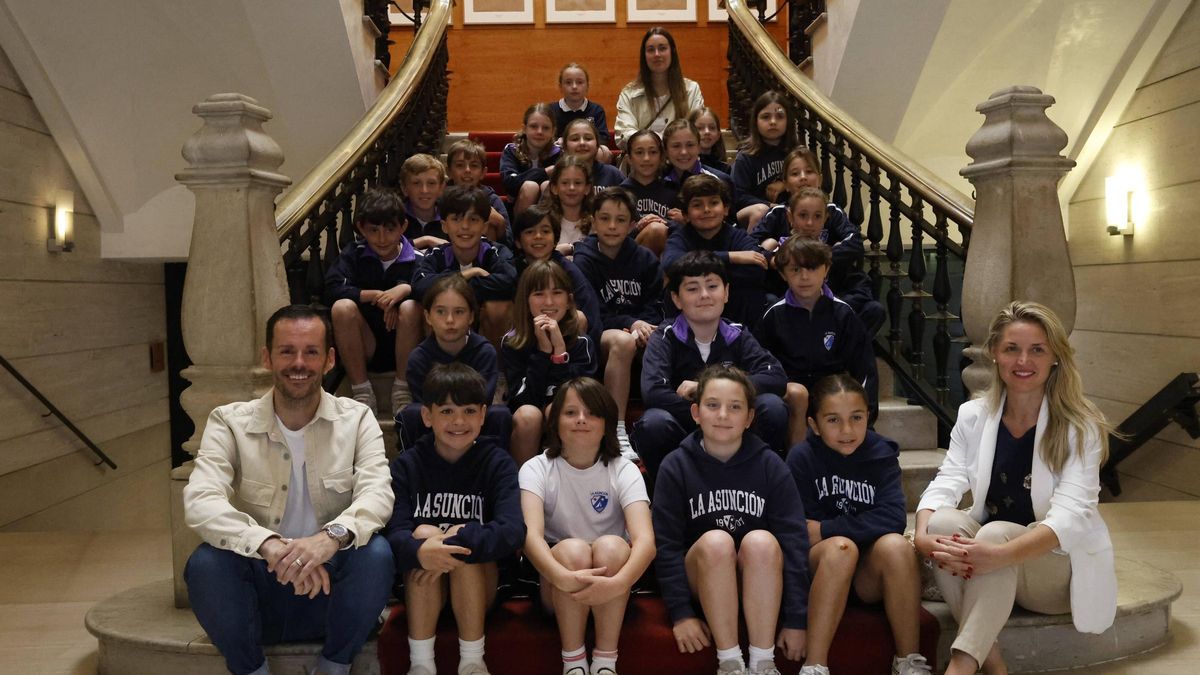 Los escolares del colegio de La Asunción, sentados junto a sus profesores en las escaleras de la Casa Consistorial.
