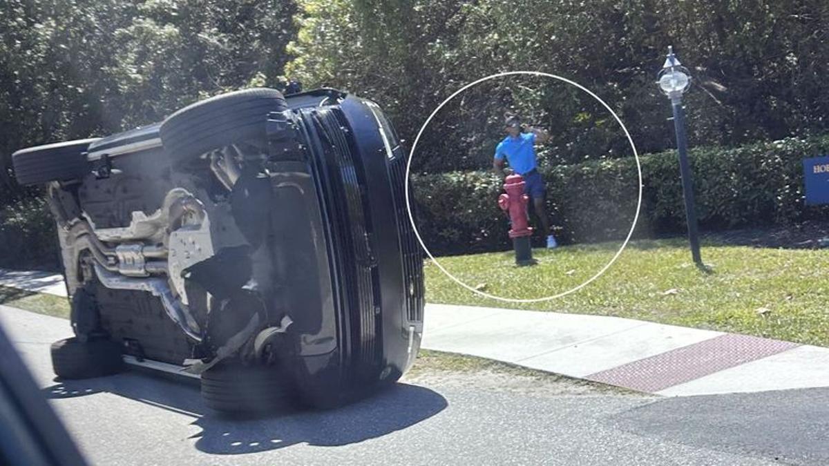 El golfista, fotografiado junto a su Land Rover, hablando por teléfono, poco después del accidente