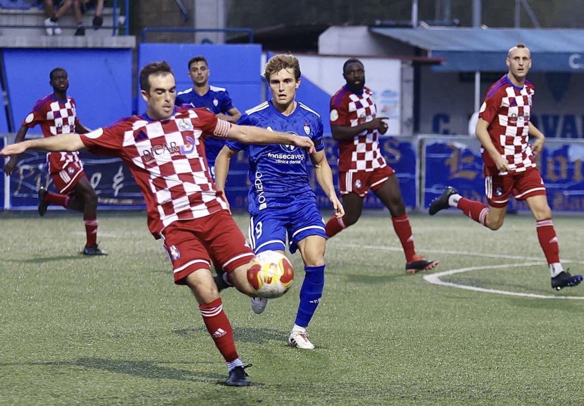 Viti trata de golpear el balón ante el jugador del Covadonga Guille Cueto. |