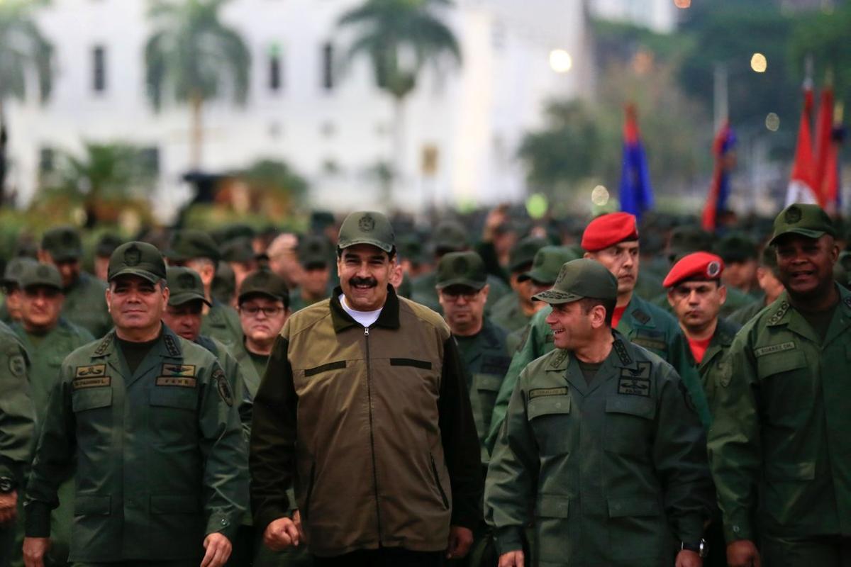 Venezuela s President Nicolas Maduro smiles as he walks next to Venezuela s Defense Minister Vladimir Padrino Lopez and Remigio Ceballos  Strategic Operational Commander of the Bolivarian National Armed Forces  during a ceremony at a military base in Caracas  Venezuela May 2  2019  Miraflores Palace Handout via REUTERS ATTENTION EDITORS - THIS PICTURE WAS PROVIDED BY A THIRD PARTY