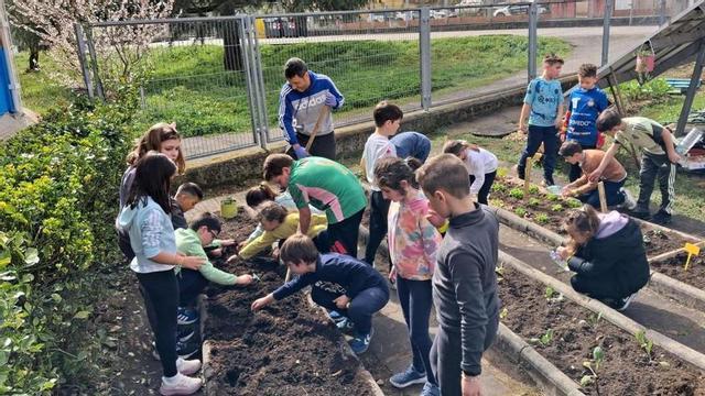 Escolinos trabayando  na güerta.