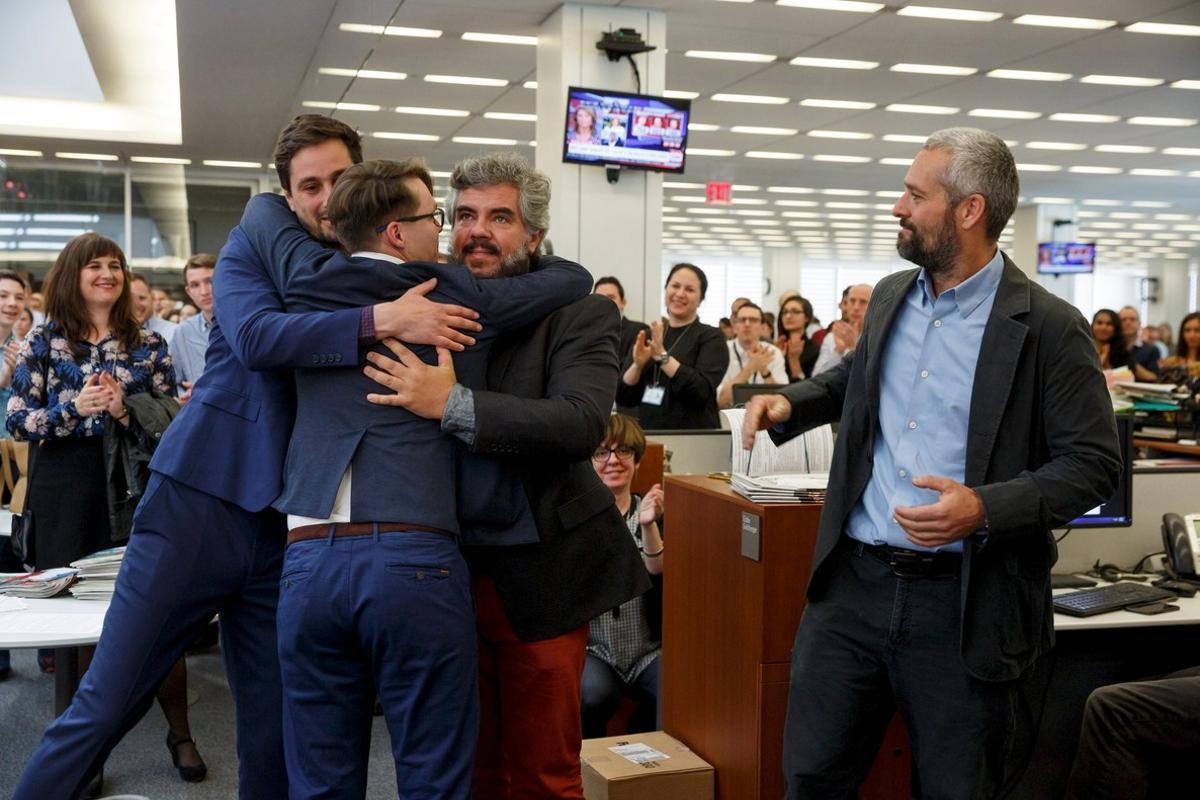 New York Times photographers Daniel Etter, Sergey Ponomarev, Mauricio Lima and Tyler Hicks (L-R) react as they are applauded by their colleagues in the newsroom after winning the 2016 Pulitzer Prize for Breaking News Photography in New York, April 18, 2016. The Times shared the award with Thomson Reuters for their images of the migrant crisis in Europe. REUTERS/Richard Perry/The New York Times/Handout via Reuters    ATTENTION EDITORS - THIS PICTURE WAS PROVIDED BY A THIRD PARTY. REUTERS IS UNABLE TO INDEPENDENTLY VERIFY THE AUTHENTICITY, CONTENT, LOCATION OR DATE OF THIS IMAGE. FOR EDITORIAL USE ONLY. NOT FOR SALE FOR MARKETING OR ADVERTISING CAMPAIGNS. FOR EDITORIAL USE ONLY. NO RESALES. NO ARCHIVE. THIS PICTURE IS DISTRIBUTED EXACTLY AS RECEIVED BY REUTERS, AS A SERVICE TO CLIENTS