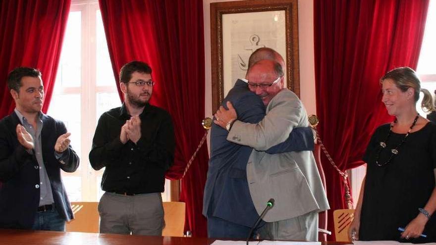 Mario Riobó y Félix Juncal se abrazan tras la investidura del alcalde en el pleno, en junio de 2011.  // D.G.P.