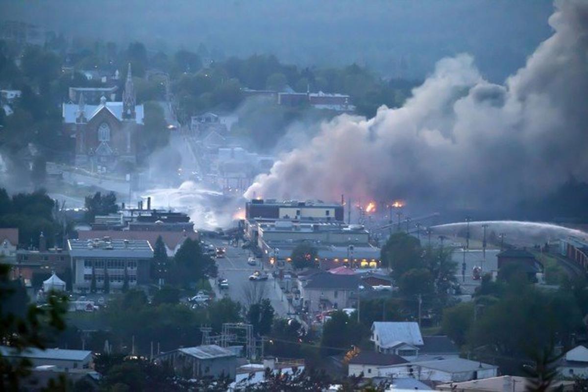 Una columna de fum procedent del tren s’eleva sobre la població de Lac-Mégantic, dissabte. Una columna de fum procedent del tren s’eleva sobre la població de Lac-Mégantic, dissabte.