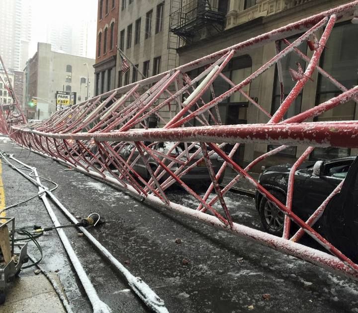 A row of cars are crushed by a massive construction crane collapse on a street in downtown Manhattan in New York