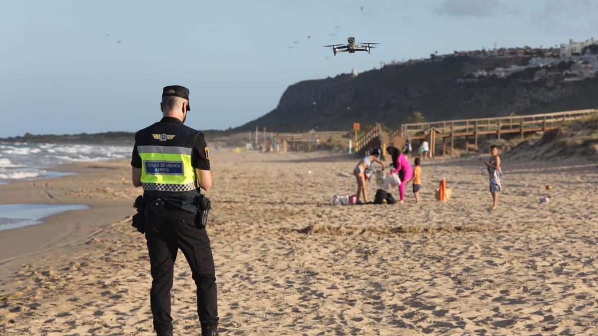 Un Policía Local de Elche maneja un dron en la playa de Arenales el miércoles por la tarde, la noche de San Juan
