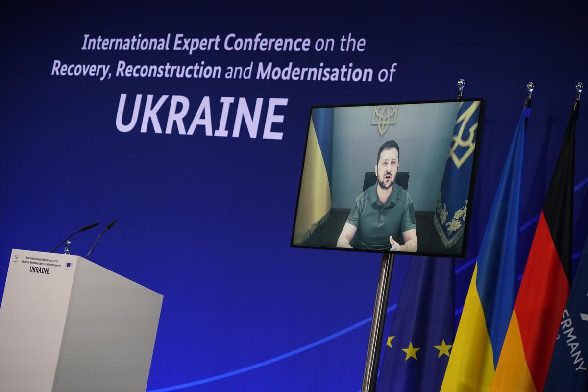 El presidente de Ucrania, Volodímir Zelenski, en la pantalla, durante su intervención en la Conferencia para la reconstrucción de Ucrania celebrada en Berlín