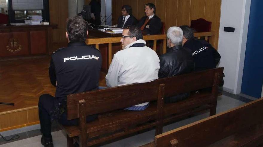 Los acusados Jacobo Costas y José Luis Mosquera, escoltados por los agentes, ayer en el juzgado.// A.V.