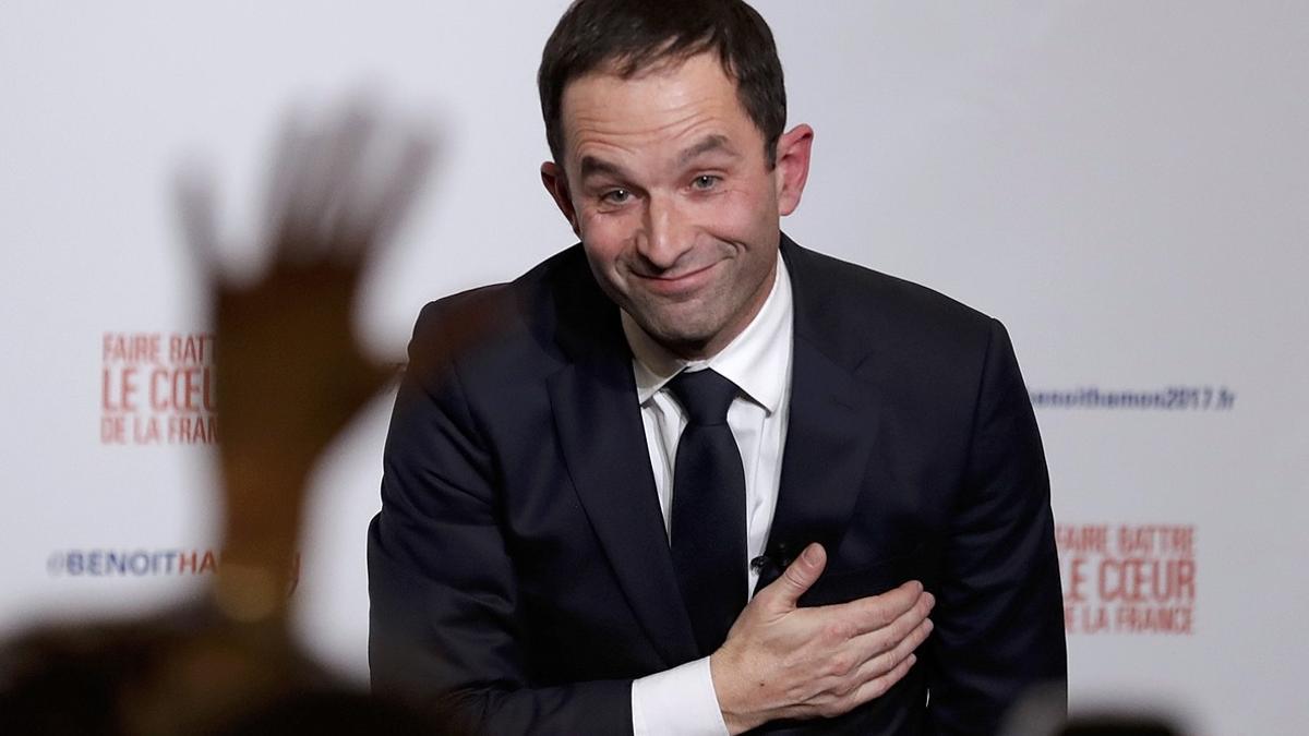 Former French education minister Benoit Hamon reacts after partial results in the second round of the French left's presidential primary election in Paris