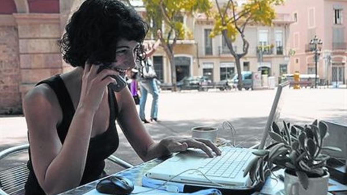 Una joven se conecta a internet desde una terraza de Barcelona.
