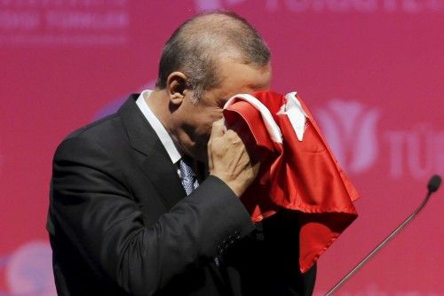 Erdogan kisses a handmade Turkish flag during a graduation ceremony in Ankara