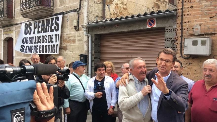 Feijóo abraza a un vecino delante de la casa en la que vivió en Os Peares