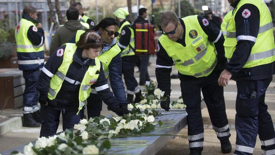 Voluntaris de la Creu Roja durant l&#039;ofrena floral.