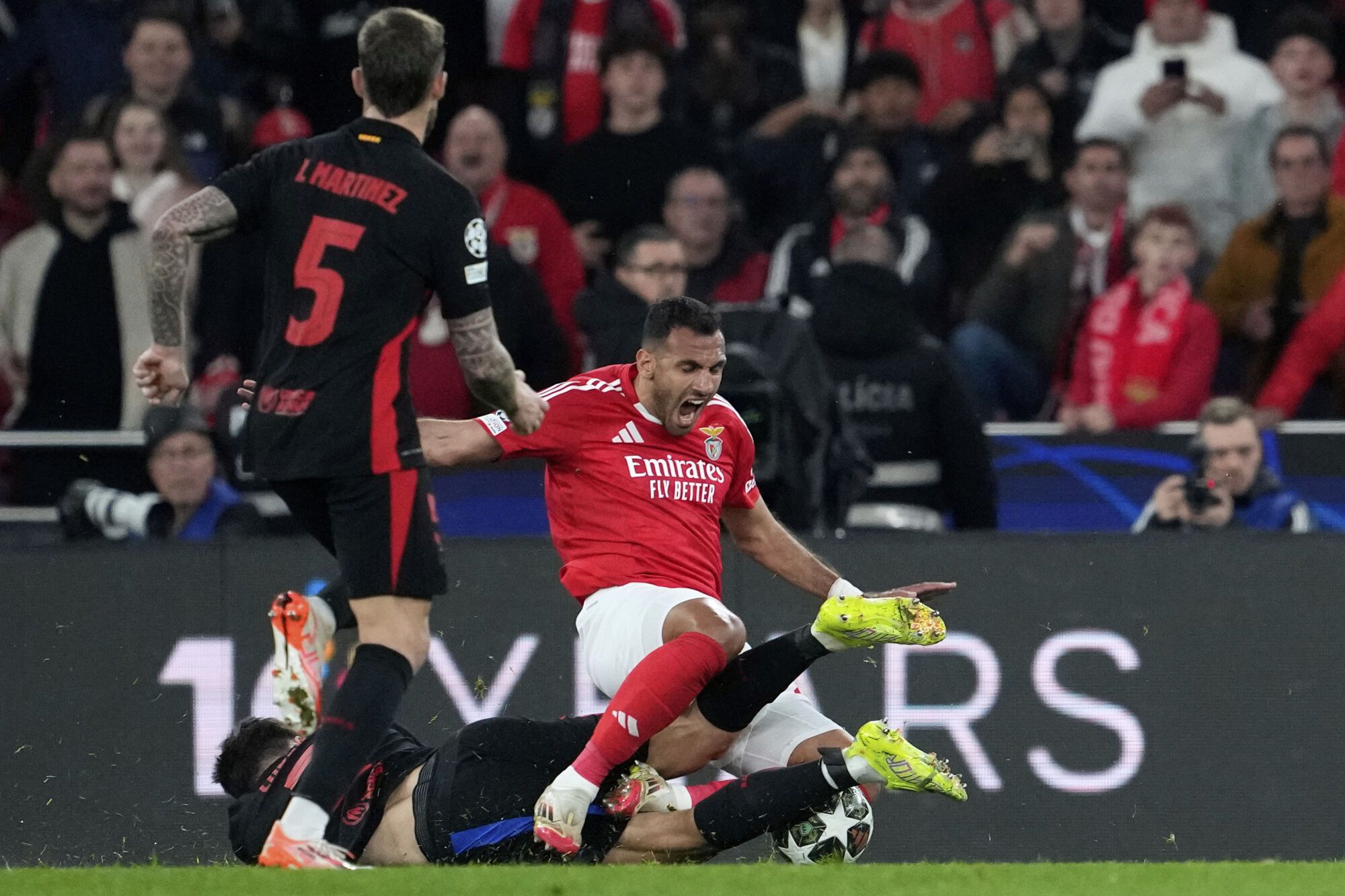 Benfica's Vangelis Pavlidis, right, is challenged by Barcelona's Pau Cubarsi during the Champions League round of 16 first leg soccer match between SL Benfica and FC Barcelona at the Luz stadium in Lisbon, Wednesday, March 5, 2025. (AP Photo/Armando Franca). EDITORIAL USE ONLY / ONLY ITALY AND SPAIN