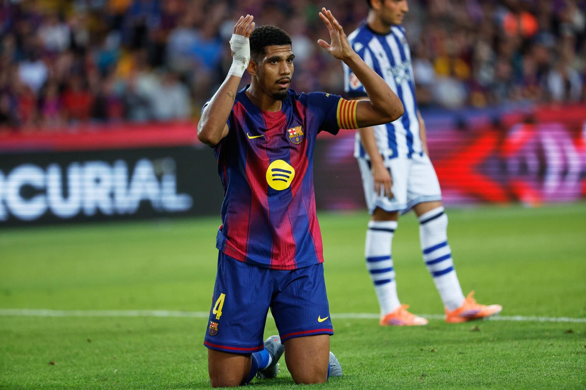 Barcelona's Ronald Araujo reacts during a Spanish La Liga soccer match between FC Barcelona and Real Sociedad at the Lluis Companys Olympic Stadium in Barcelona, Spain, Sunday, Sept. 28, 2025. (AP Photo/Joan Monfort). EDITORIAL USE ONLY/ONLY ITALY AND SPAIN
